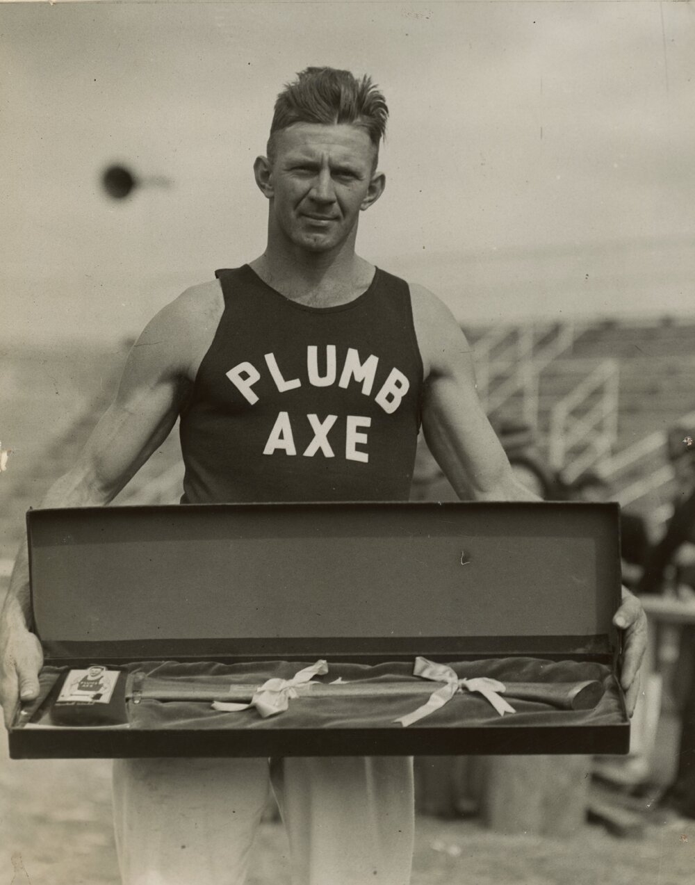 Charlie Winkel holding prize axe, c.1938