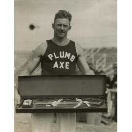 Charlie Winkel holding prize axe, c.1938
