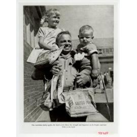 Father carrying children with showbags, 1951